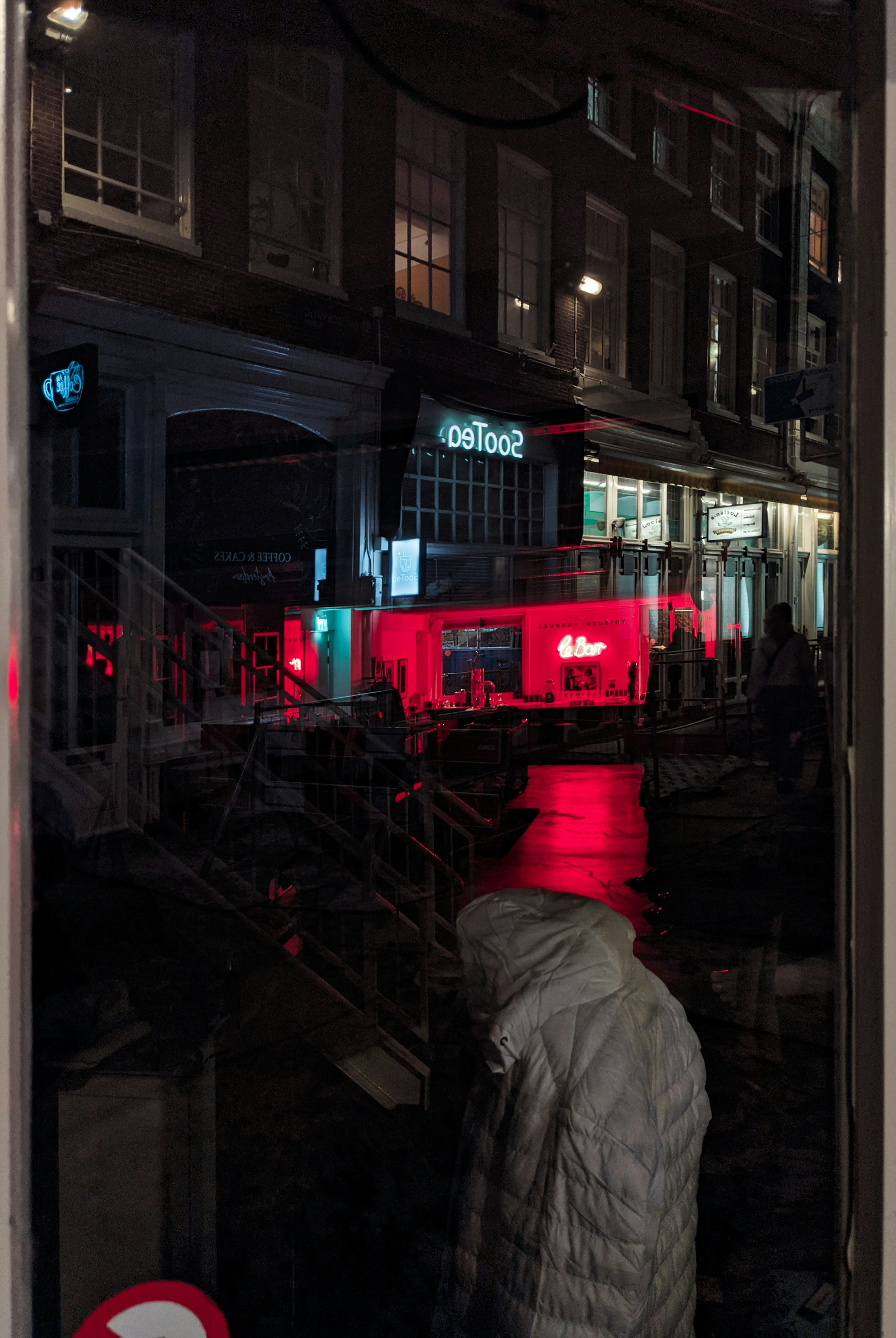 a reflection of a person in a window at night