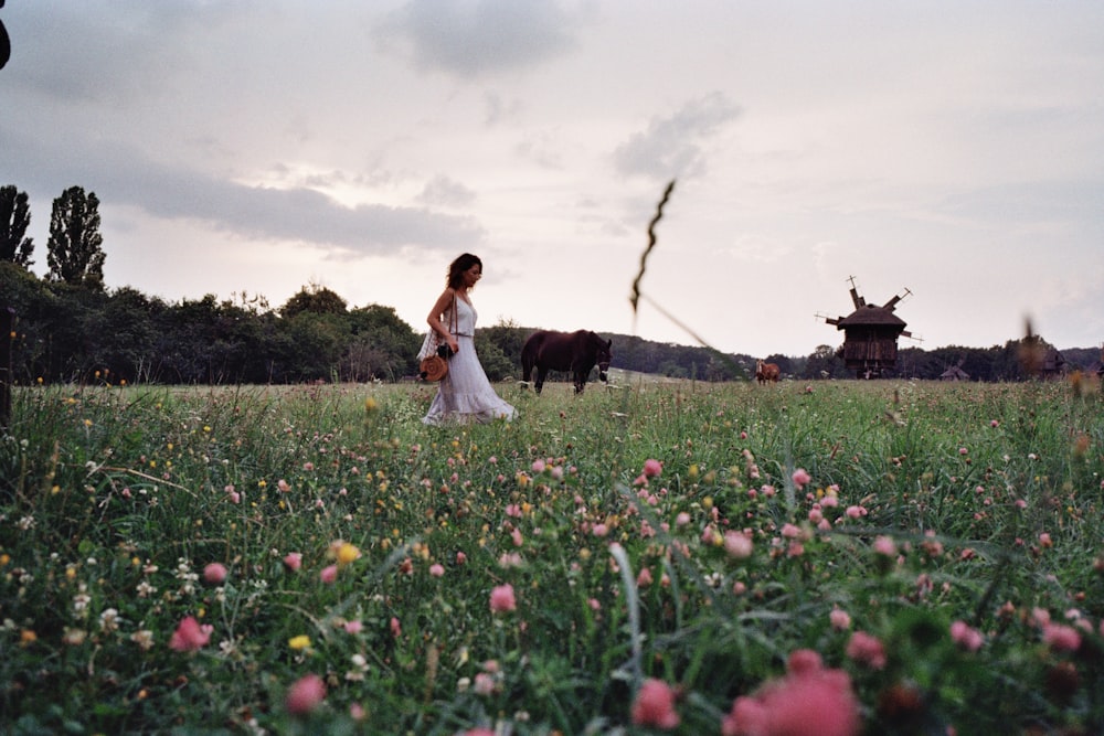 a group of people standing on top of a grass covered field