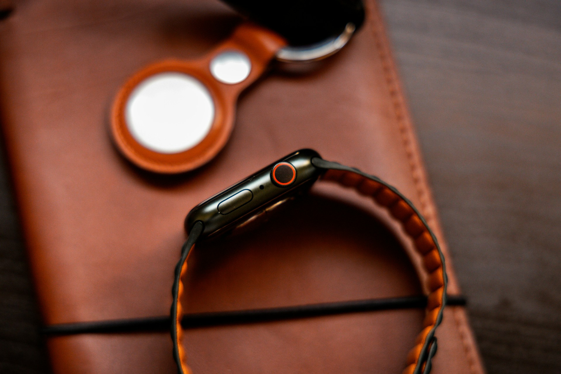 a cell phone sitting on top of a brown case