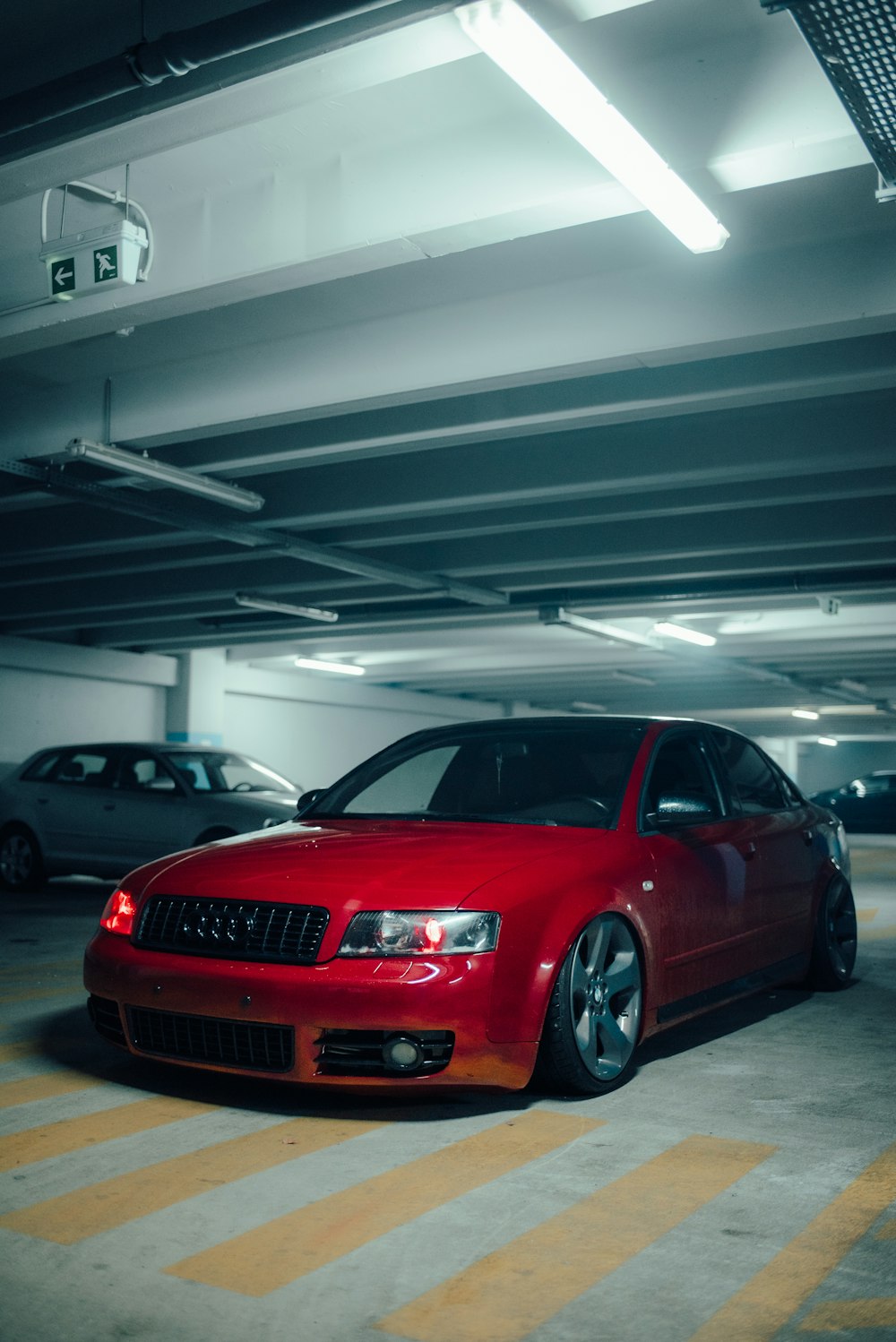 a red car parked in a parking garage