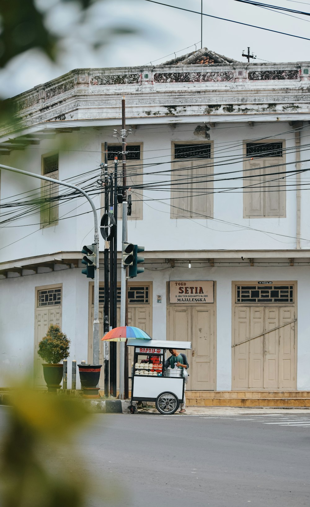 a street corner with a building and a street light