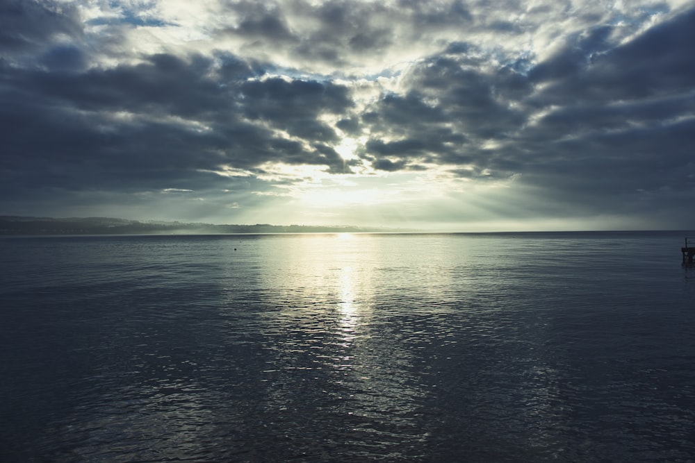 a large body of water under a cloudy sky