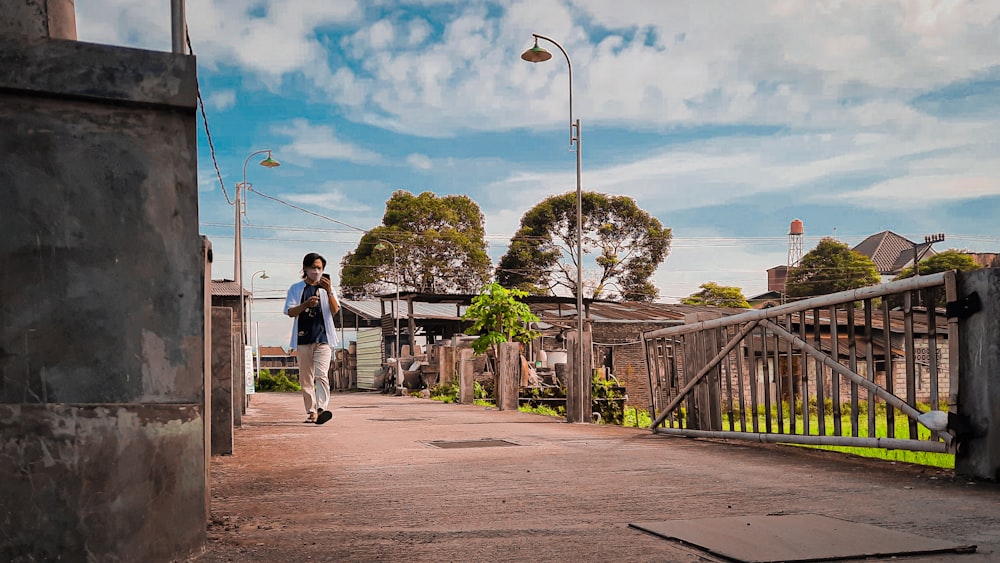 a man walking across a bridge over a river