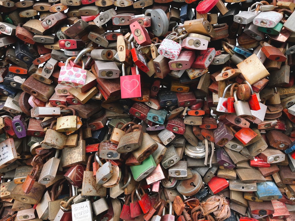 a pile of old padlocks are piled on top of each other