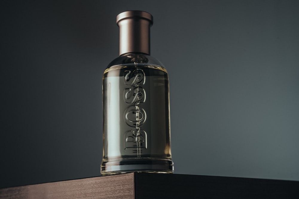 a bottle of cologne sitting on top of a wooden table