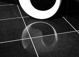 a white toilet sitting on top of a tiled floor