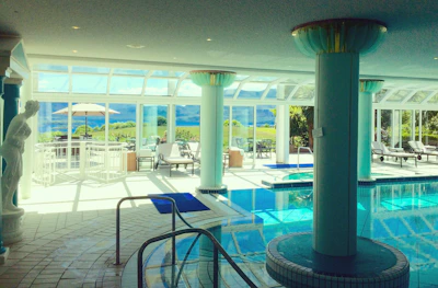 Spacious living room with floor-to-ceiling windows overlooking the pool.
