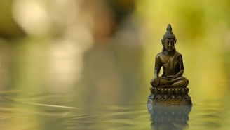 A close-up of a bronze lotus sculpture reflecting soft light.