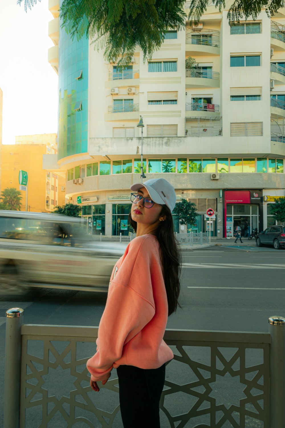 a woman standing on the side of a road