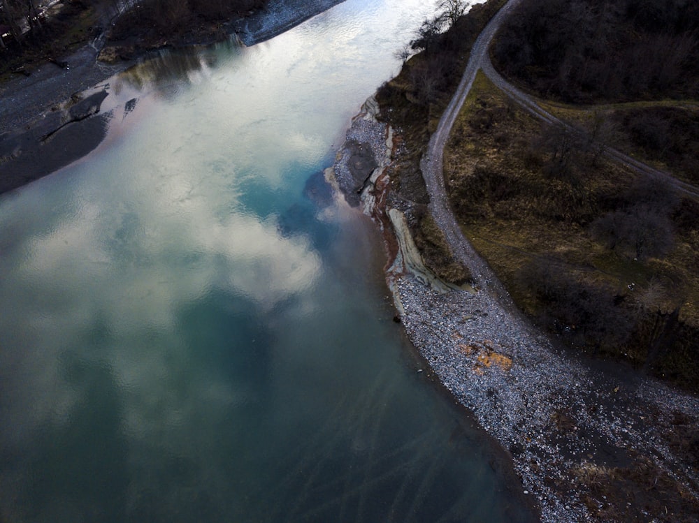 an aerial view of a river and a road