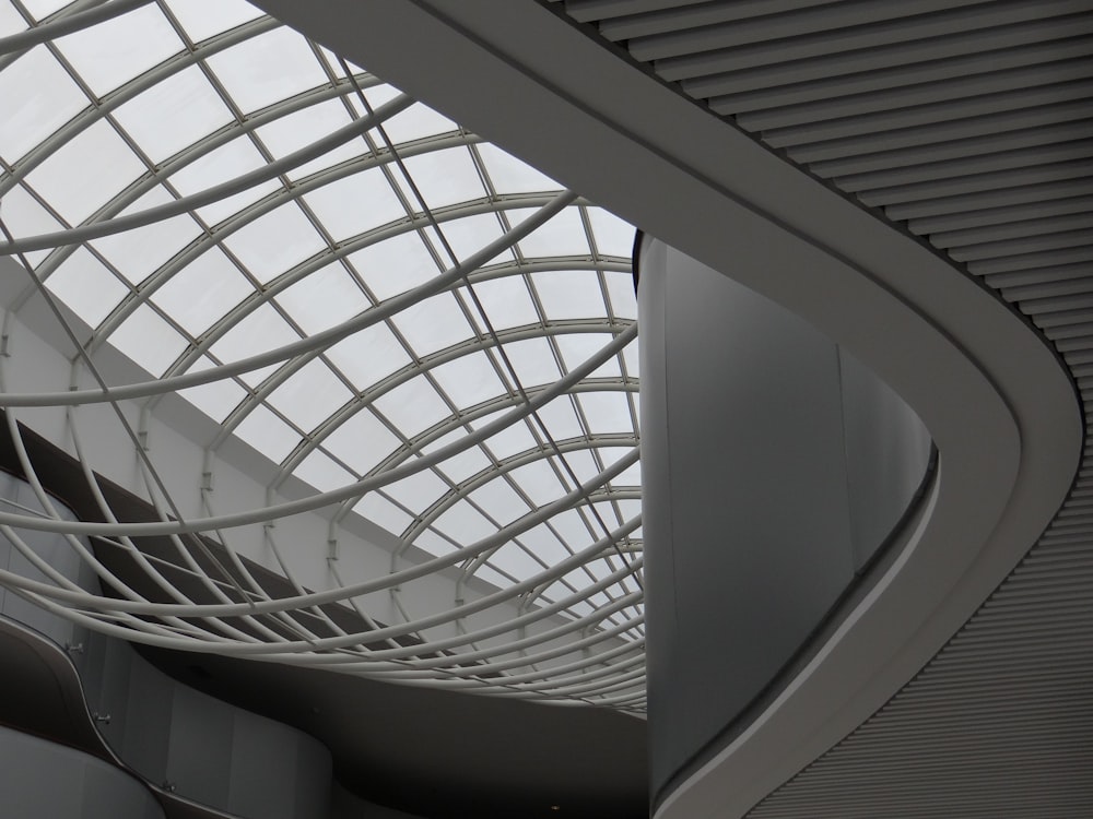 a curved white building with a skylight above it