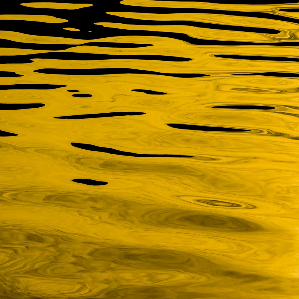 a large body of water with yellow reflections