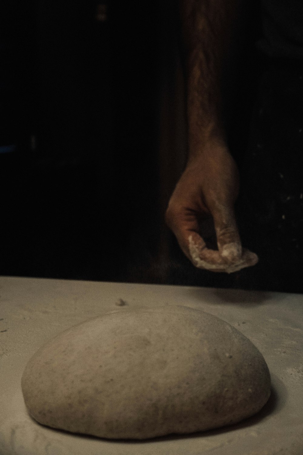 a person is kneading dough on a table