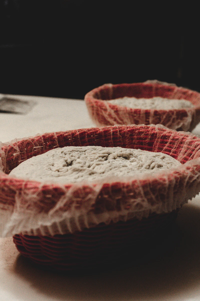 Shaped heritage grain sourdough dough in a banneton proofing basket