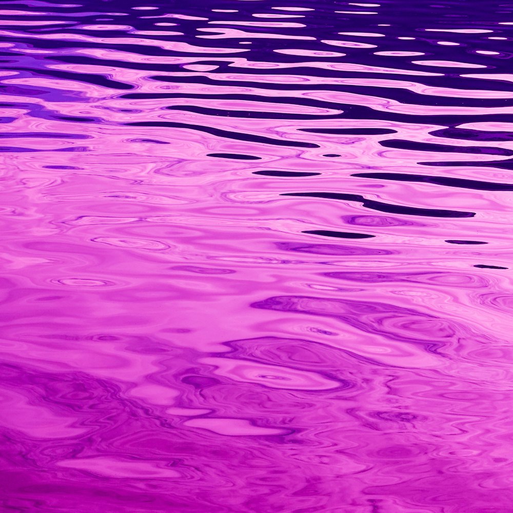 a pink and purple photo of a body of water