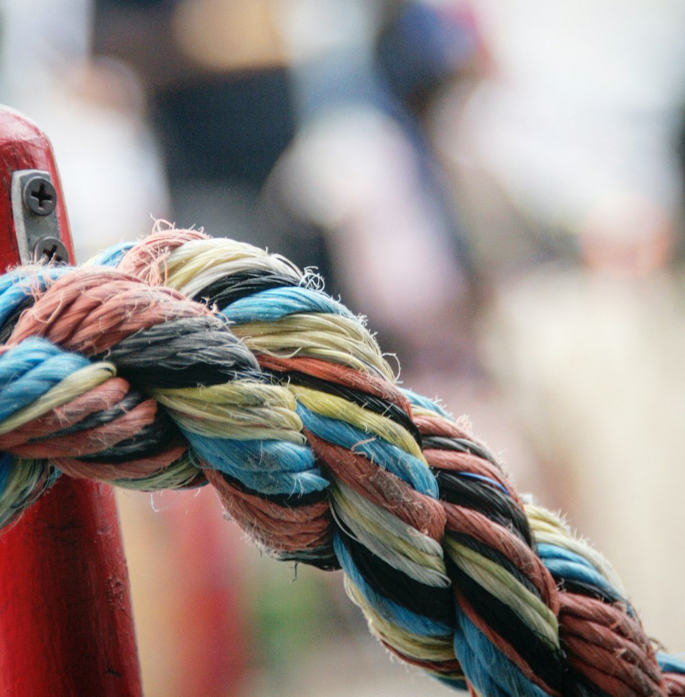 a close up of a rope attached to a red pole