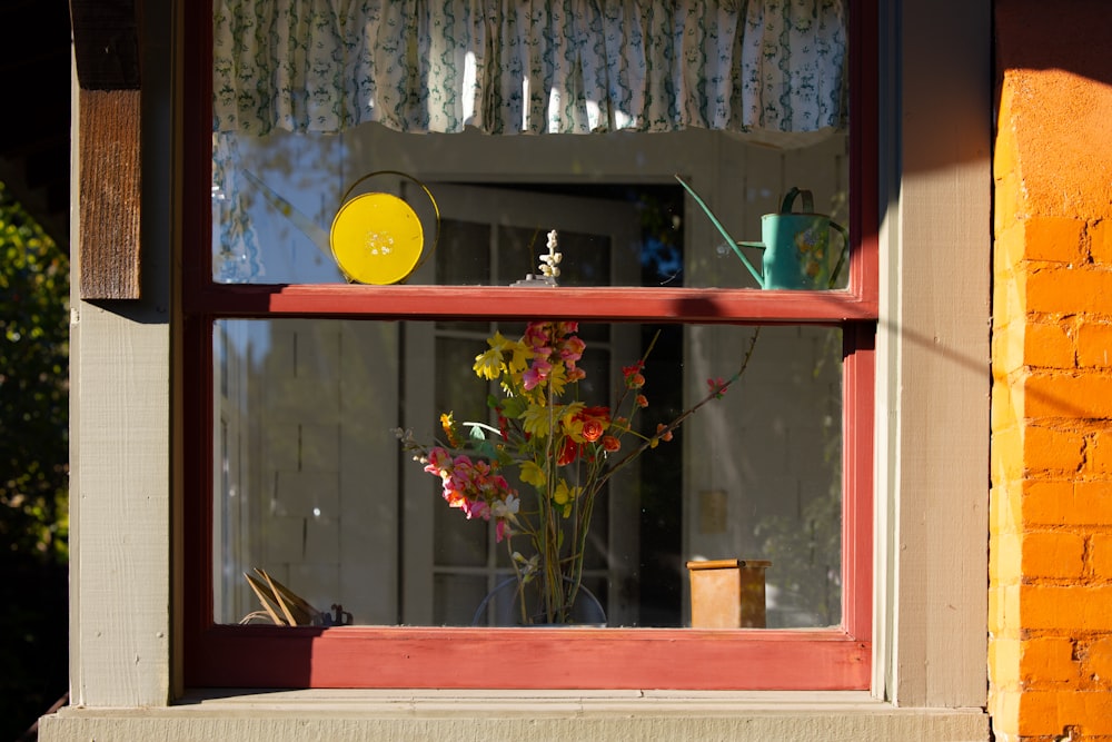 a vase of flowers sitting on a window sill