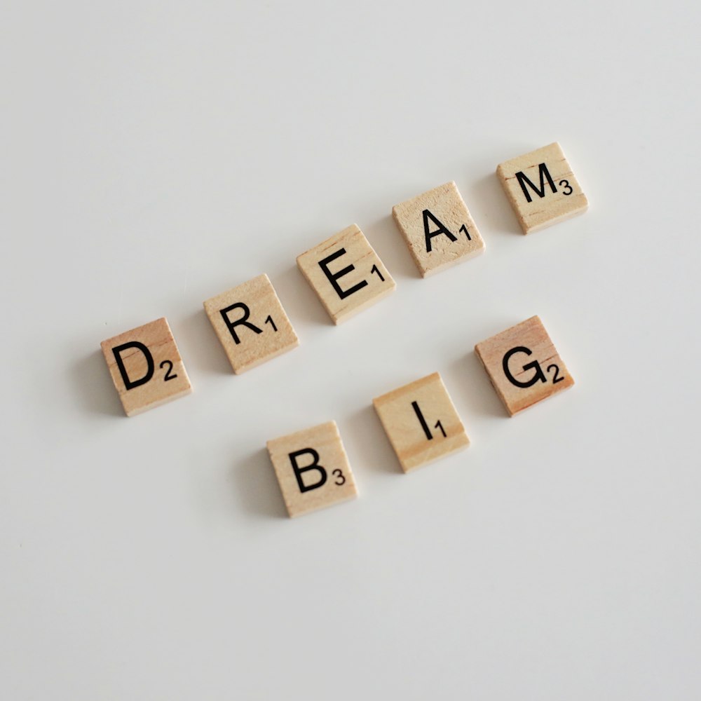 scrabble letters spelling dream, dream, and blg