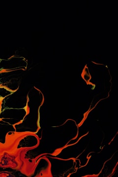 Abstract black and orange geometric shapes forming a dynamic pattern.