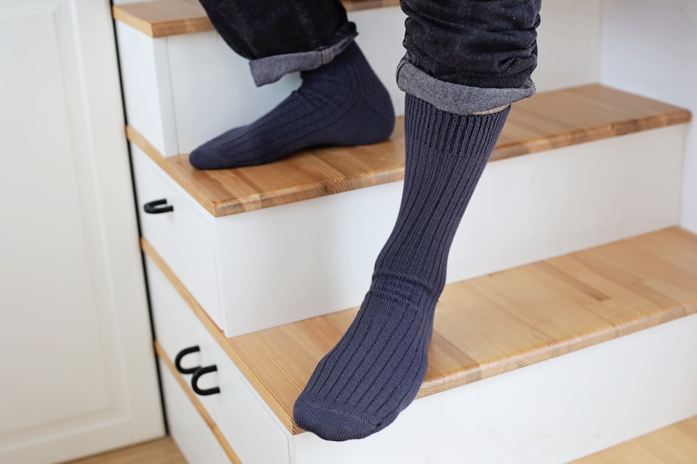 a person standing on a set of stairs wearing socks