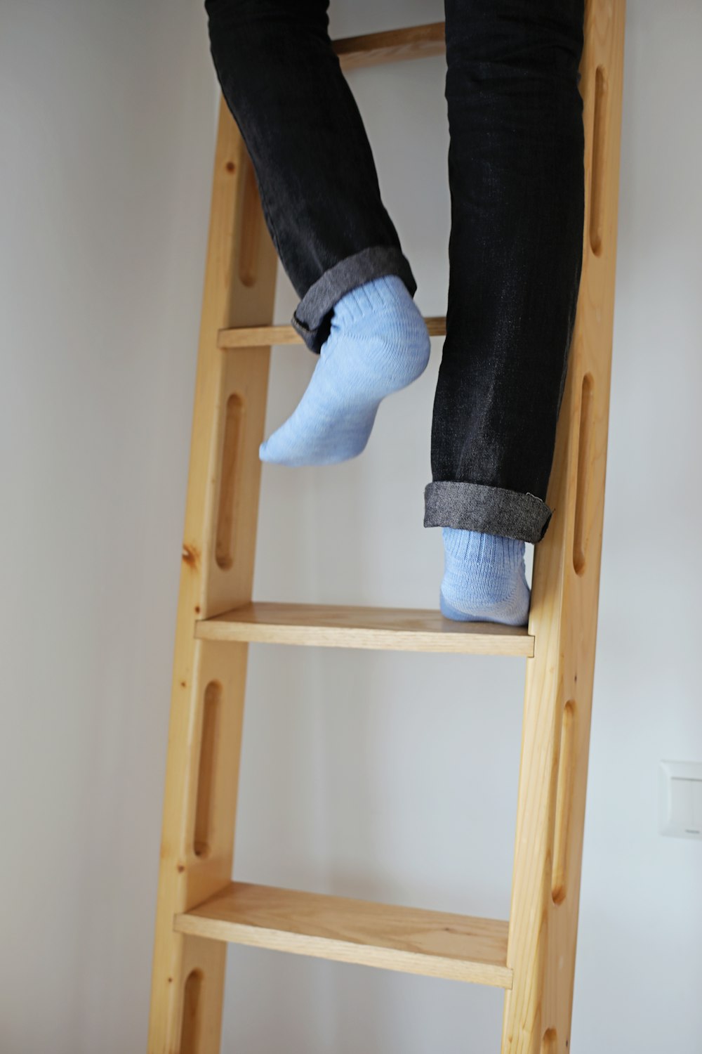a person standing on a ladder with their feet up