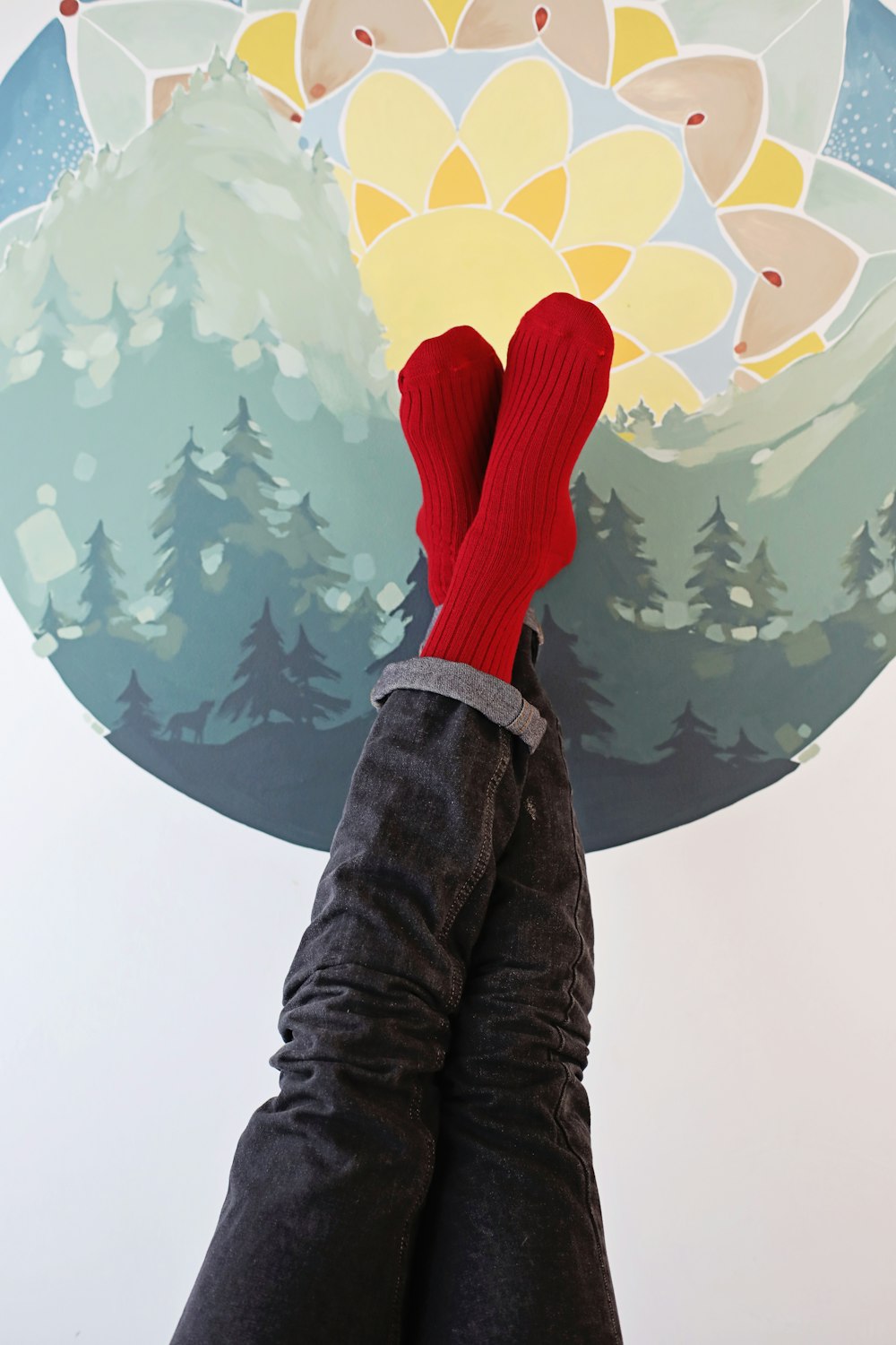 a person's feet with red socks and socks on