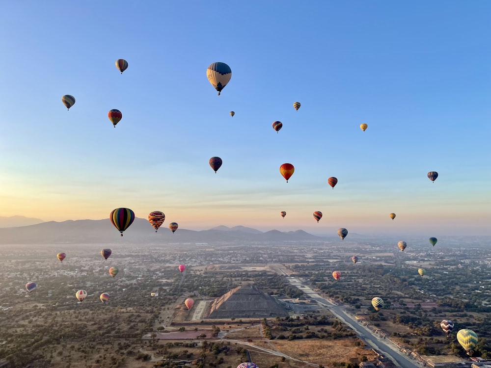 a bunch of hot air balloons flying in the sky