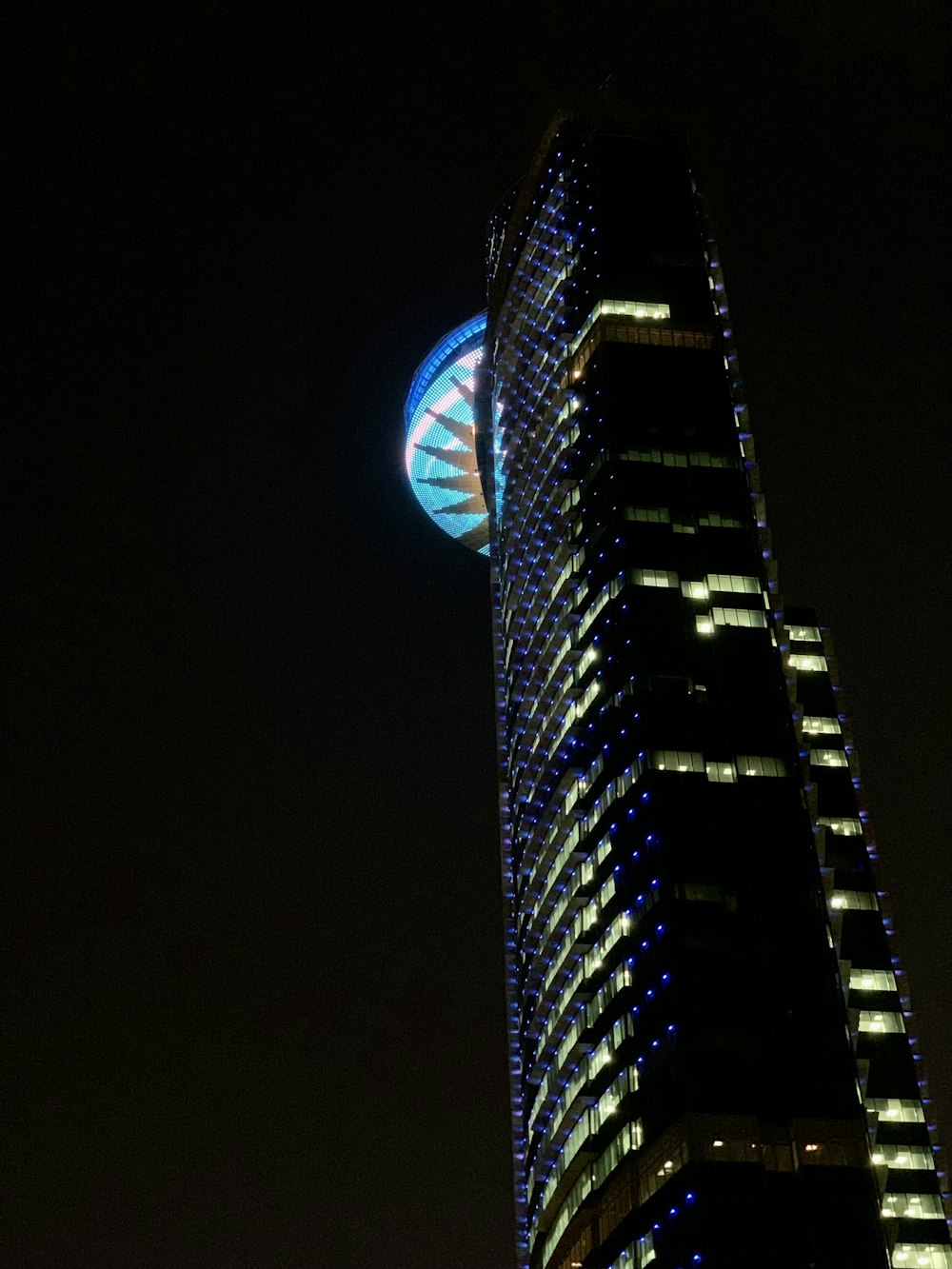 a very tall building with a clock on it's side