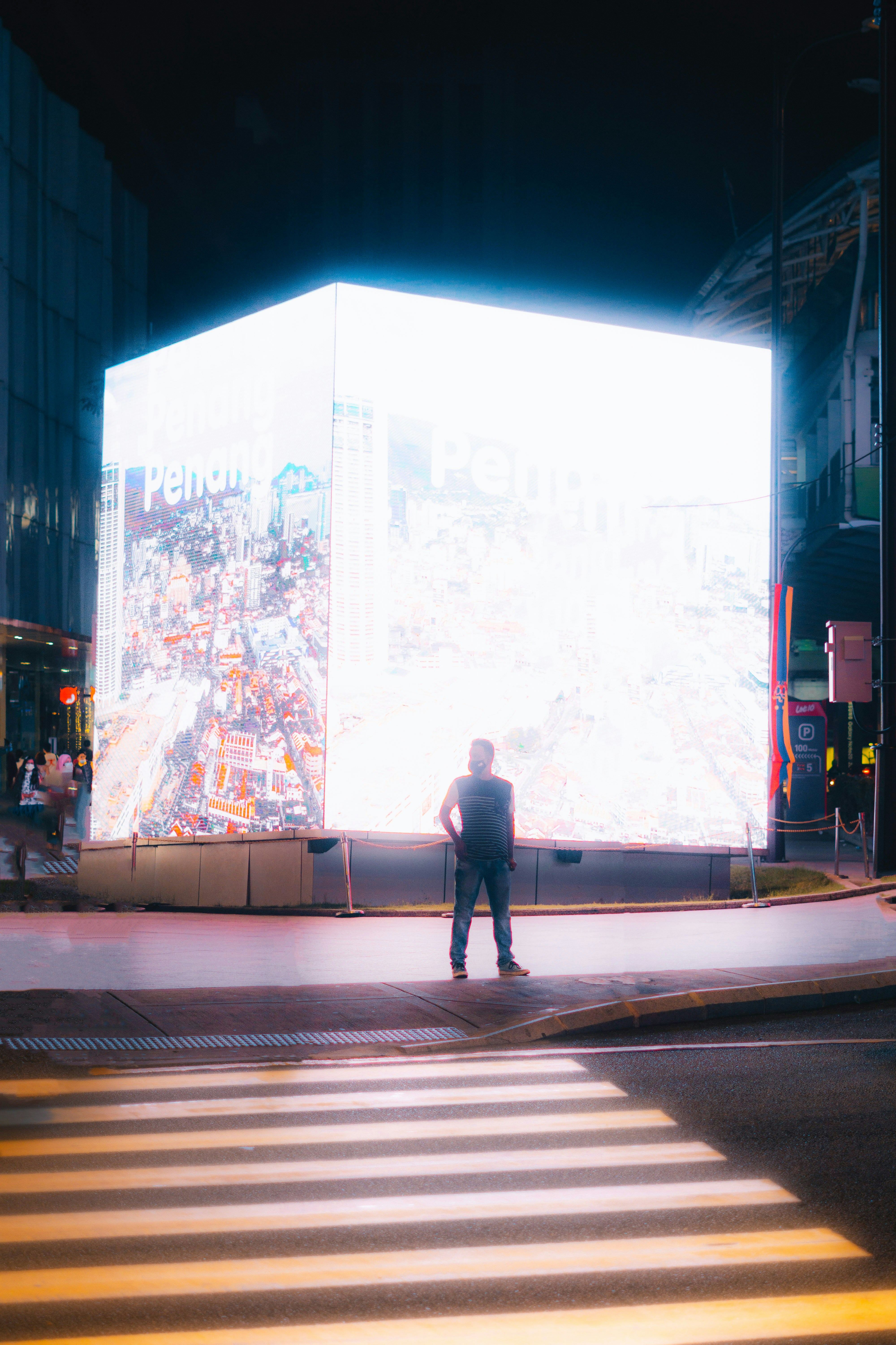 a man standing in the middle of a cross walk