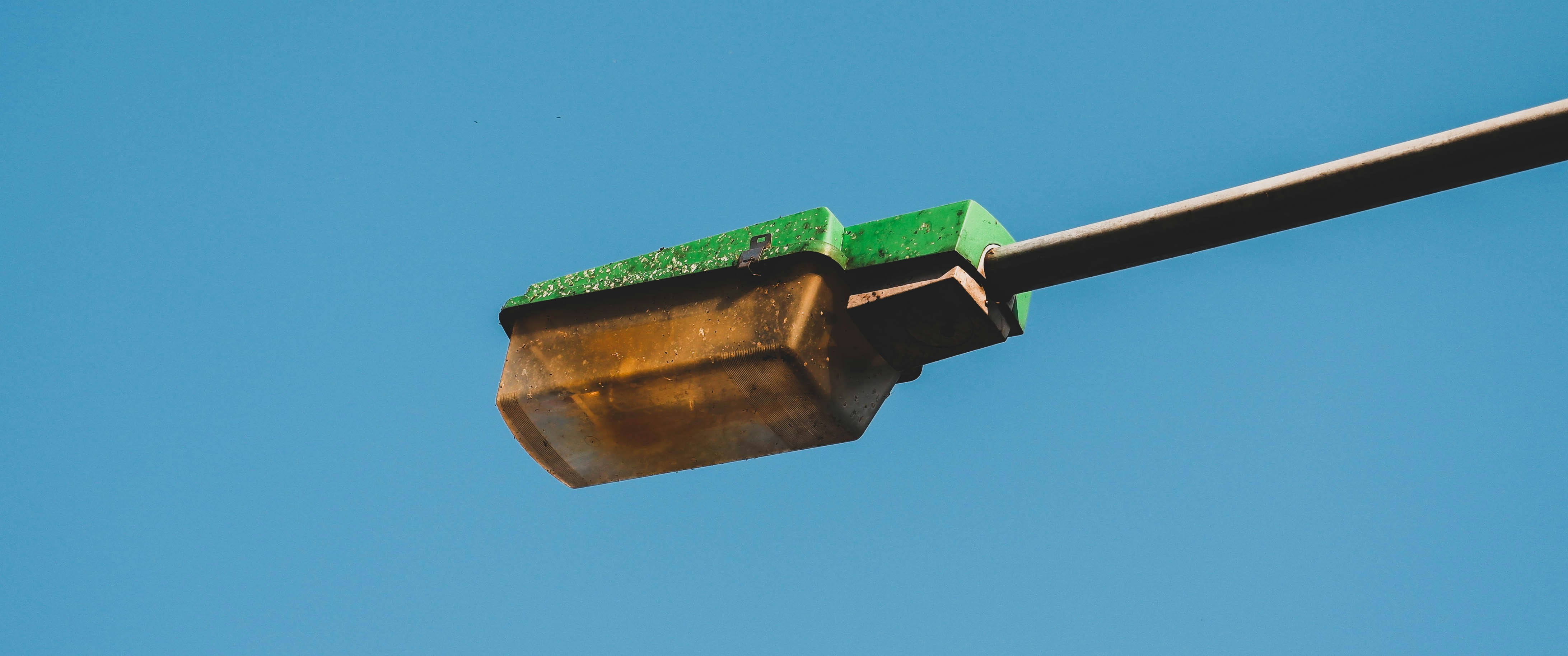 a street light with a green box on top of it