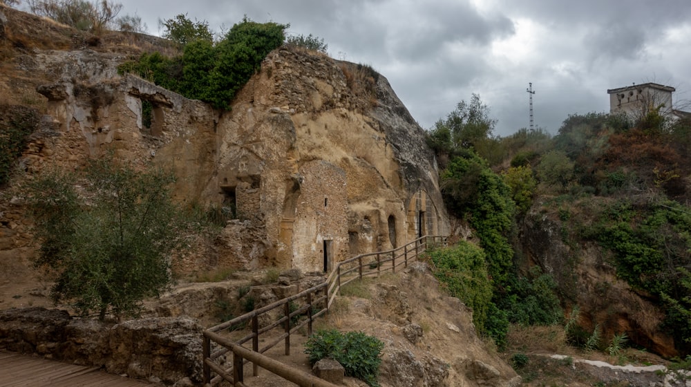 a wooden walkway leading to a cave like structure