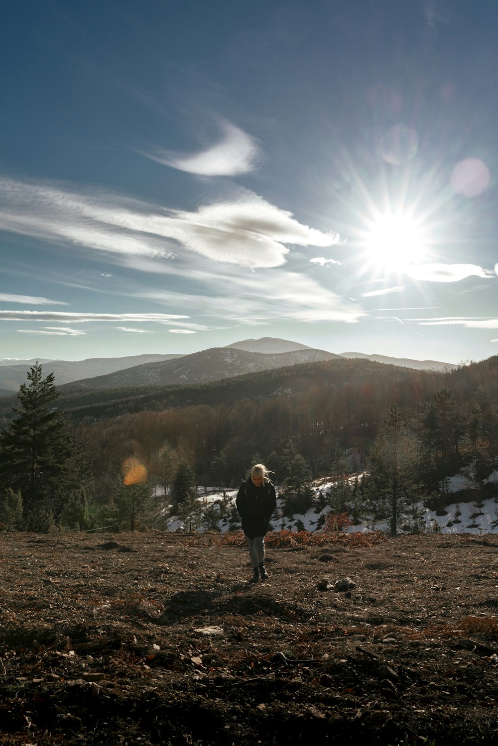 a man standing on top of a snow covered hillside