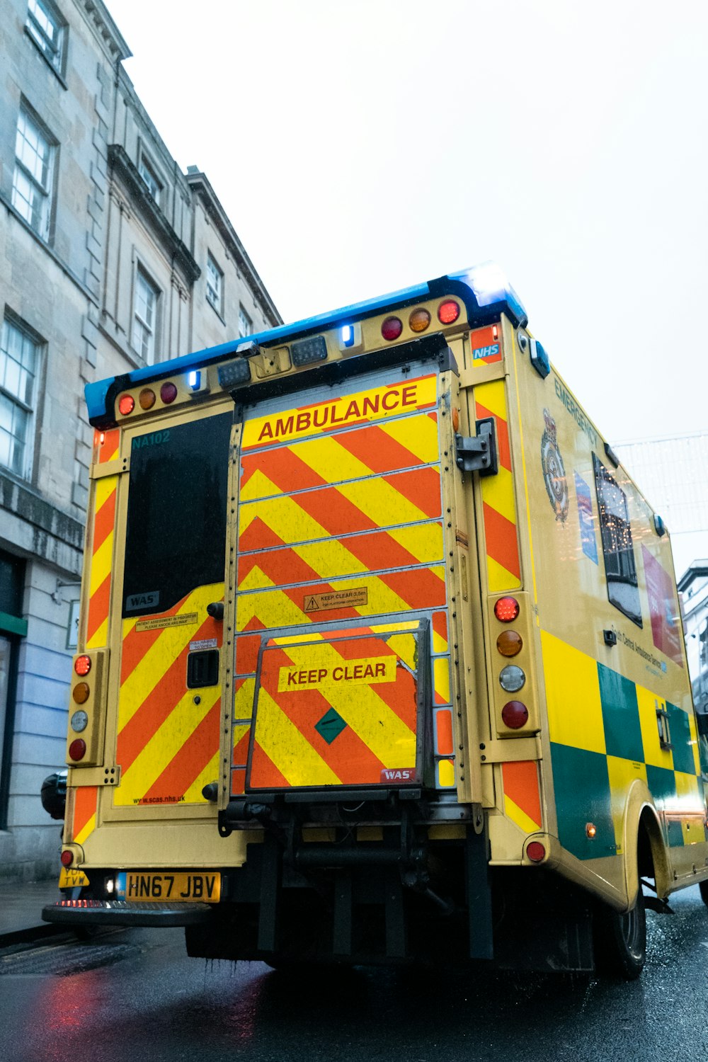 a colorful bus parked in front of a building