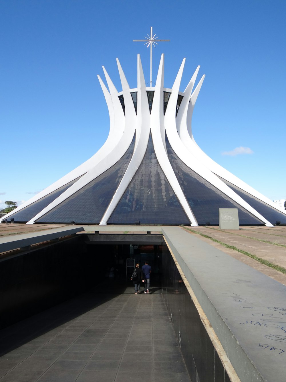 a large white building with a cross on top of it