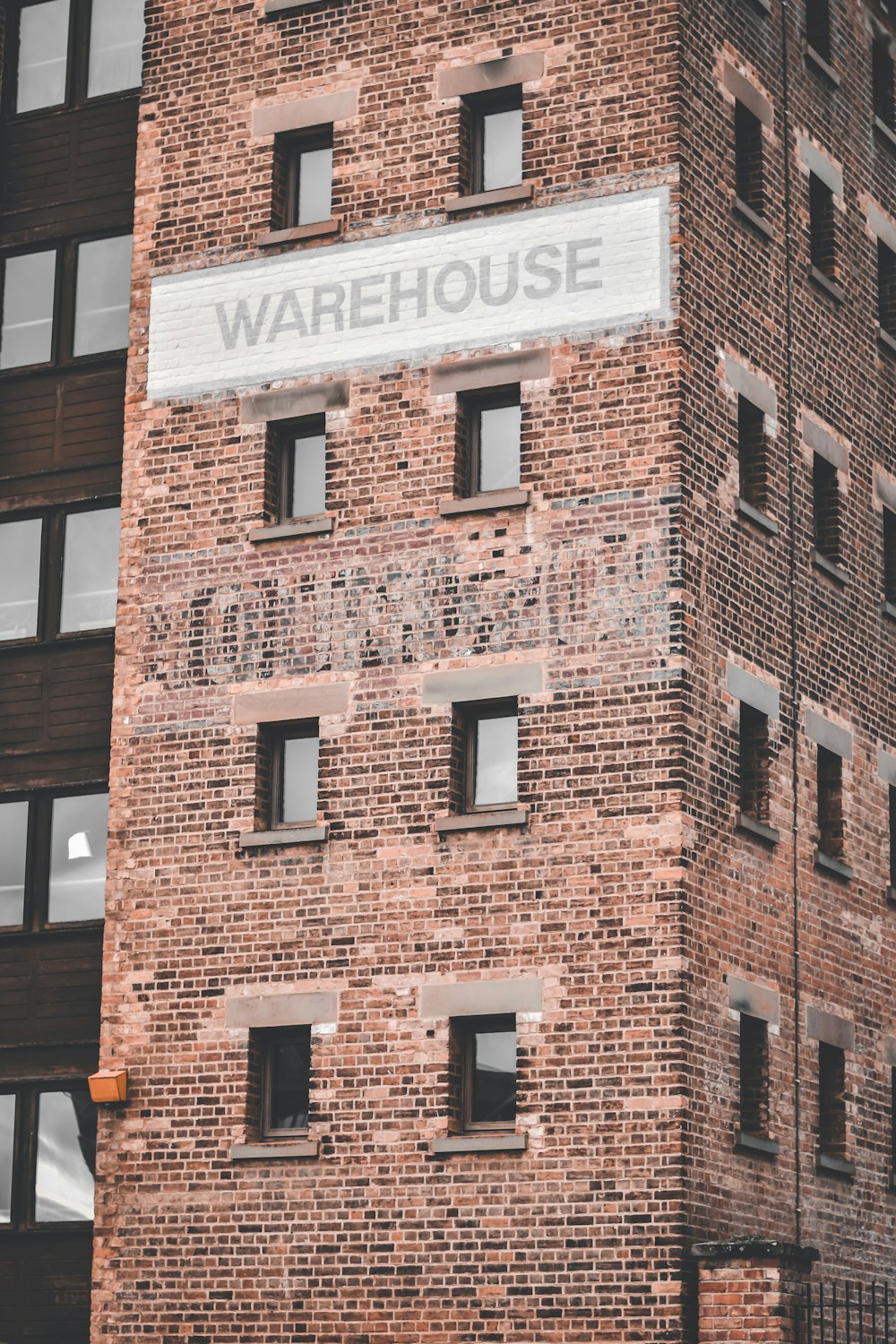 a tall brick building with a sign on it