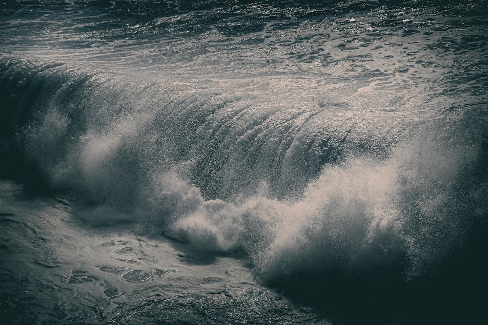 a man riding a wave on top of a body of water