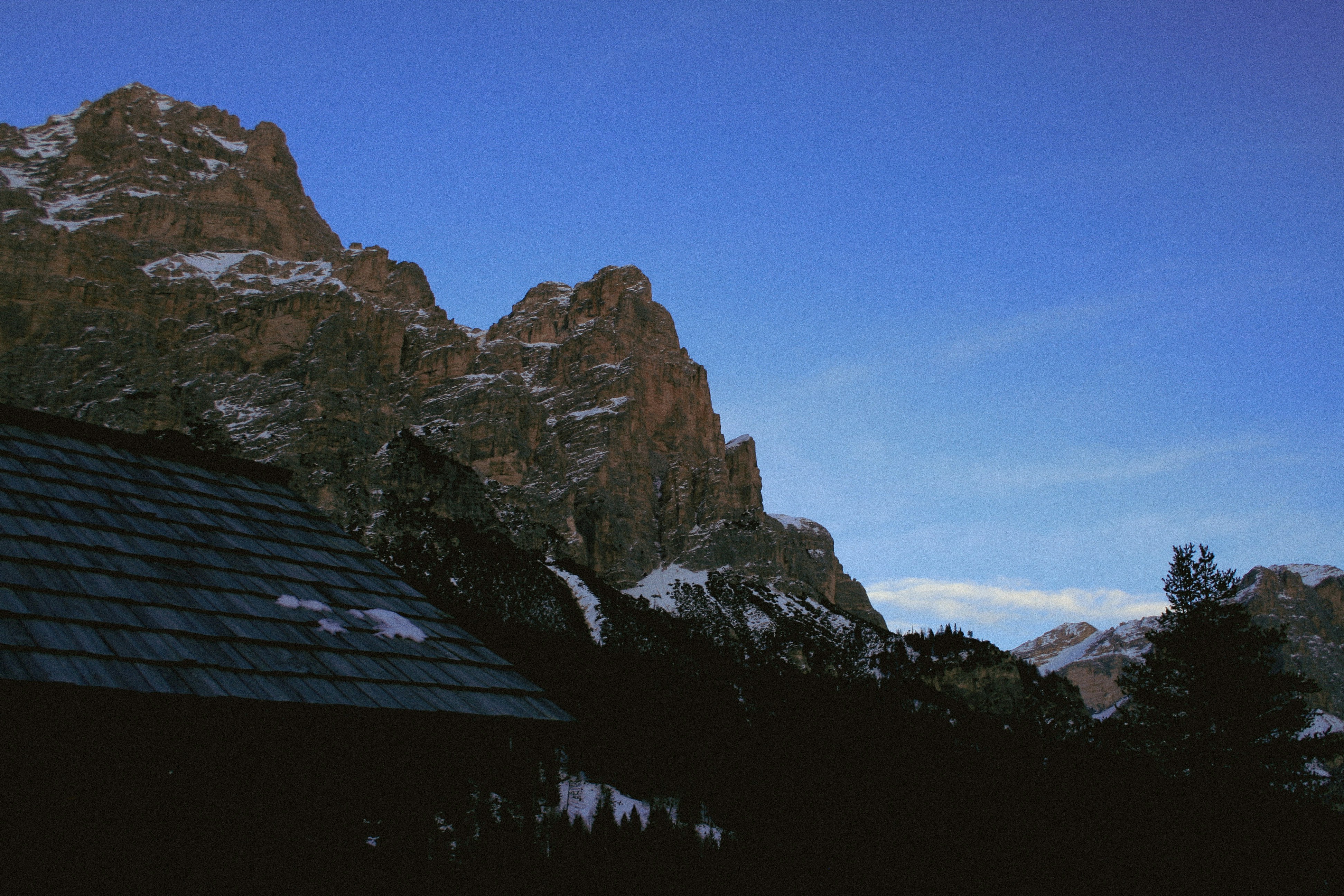 a view of a mountain range with a house in the foreground