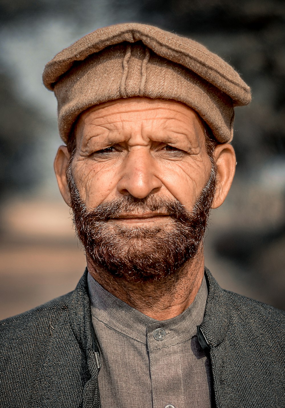 a close up of a man wearing a hat