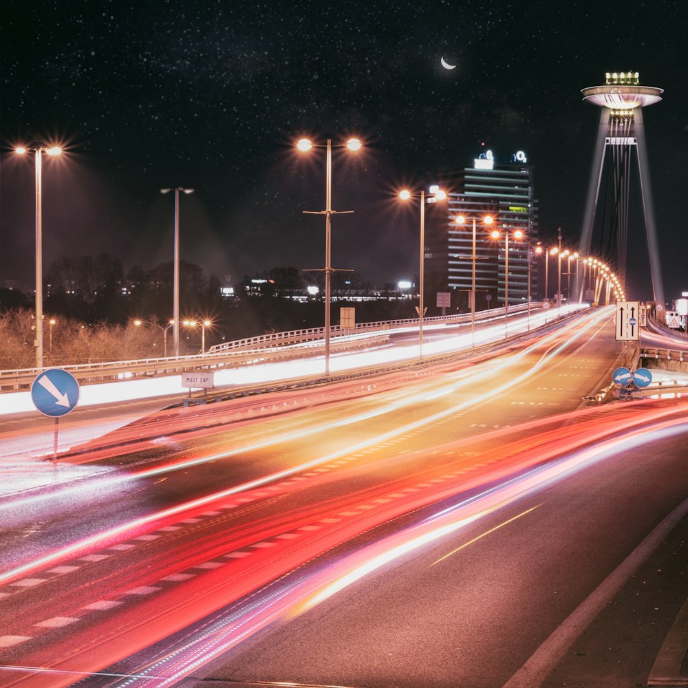 a long exposure photo of a highway at night