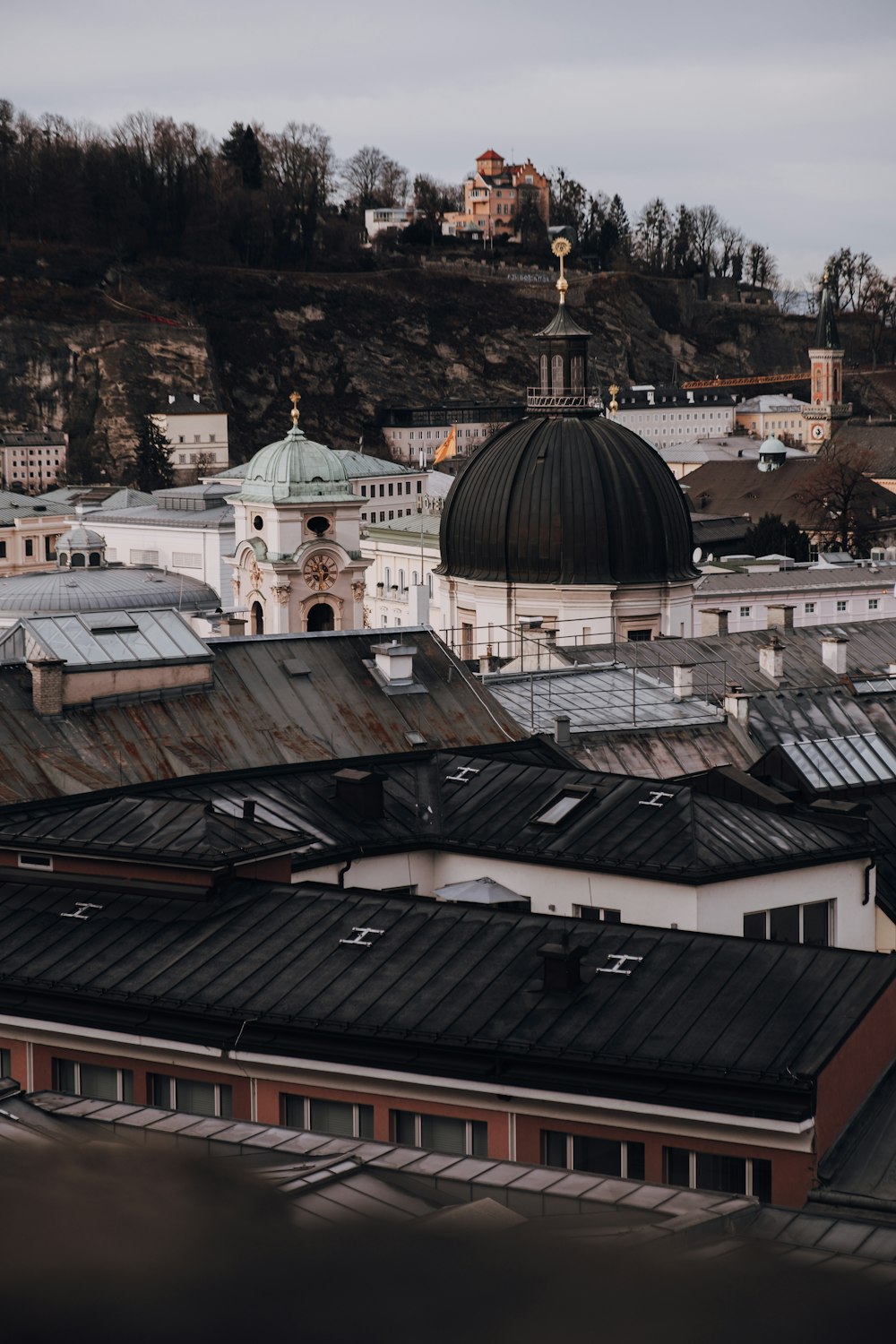 a view of a city with a church on a hill in the background