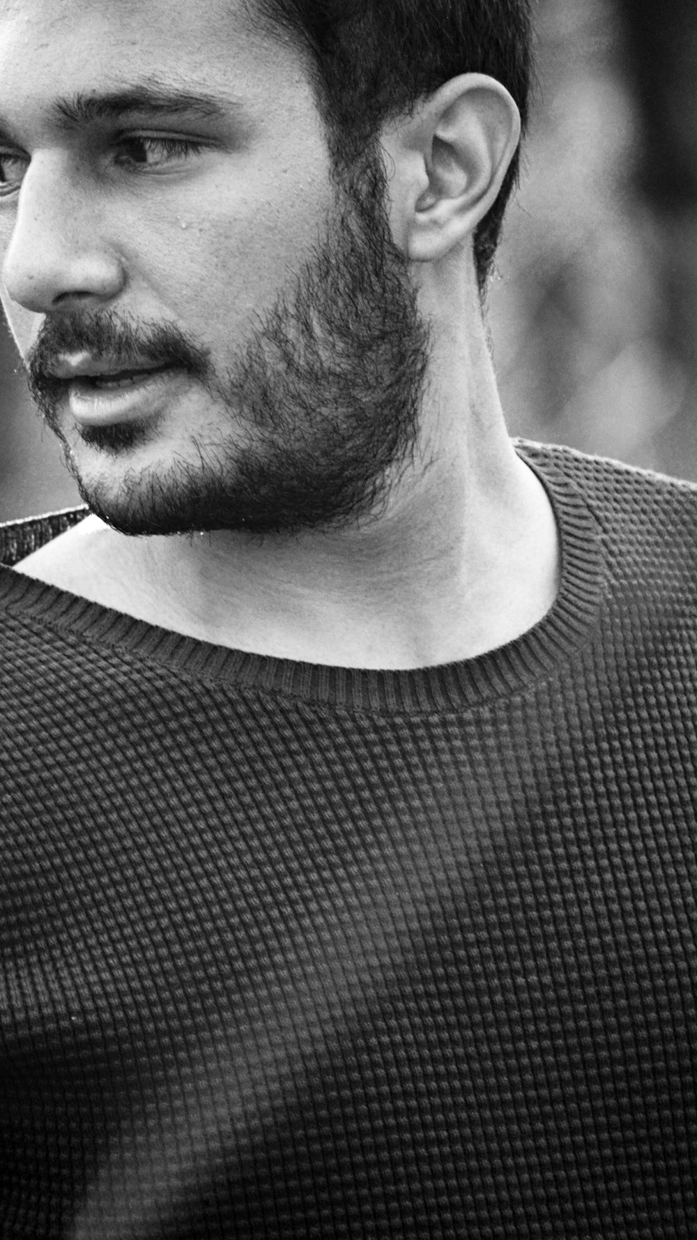 a black and white photo of a man with a beard