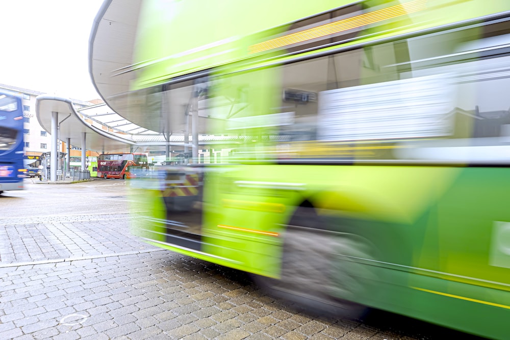 a blurry photo of a green double decker bus