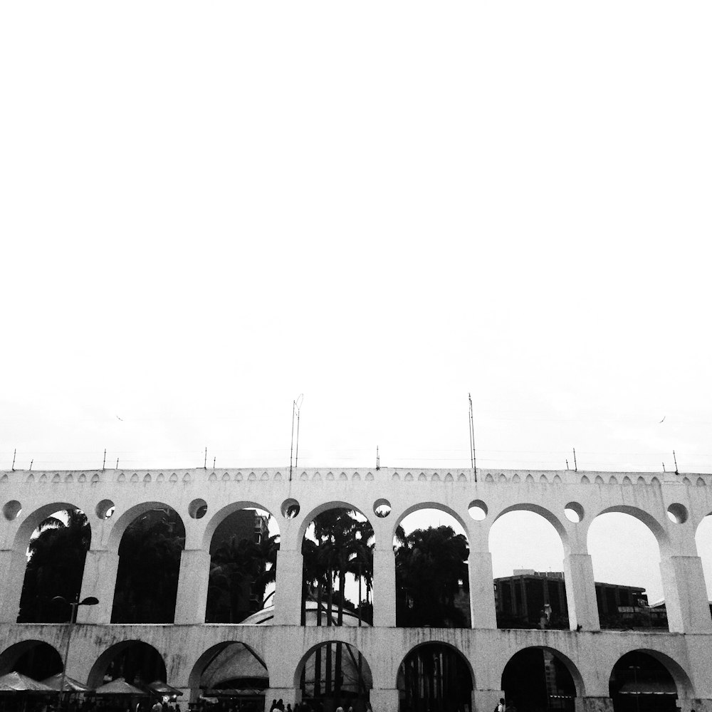 a black and white photo of a building with arches