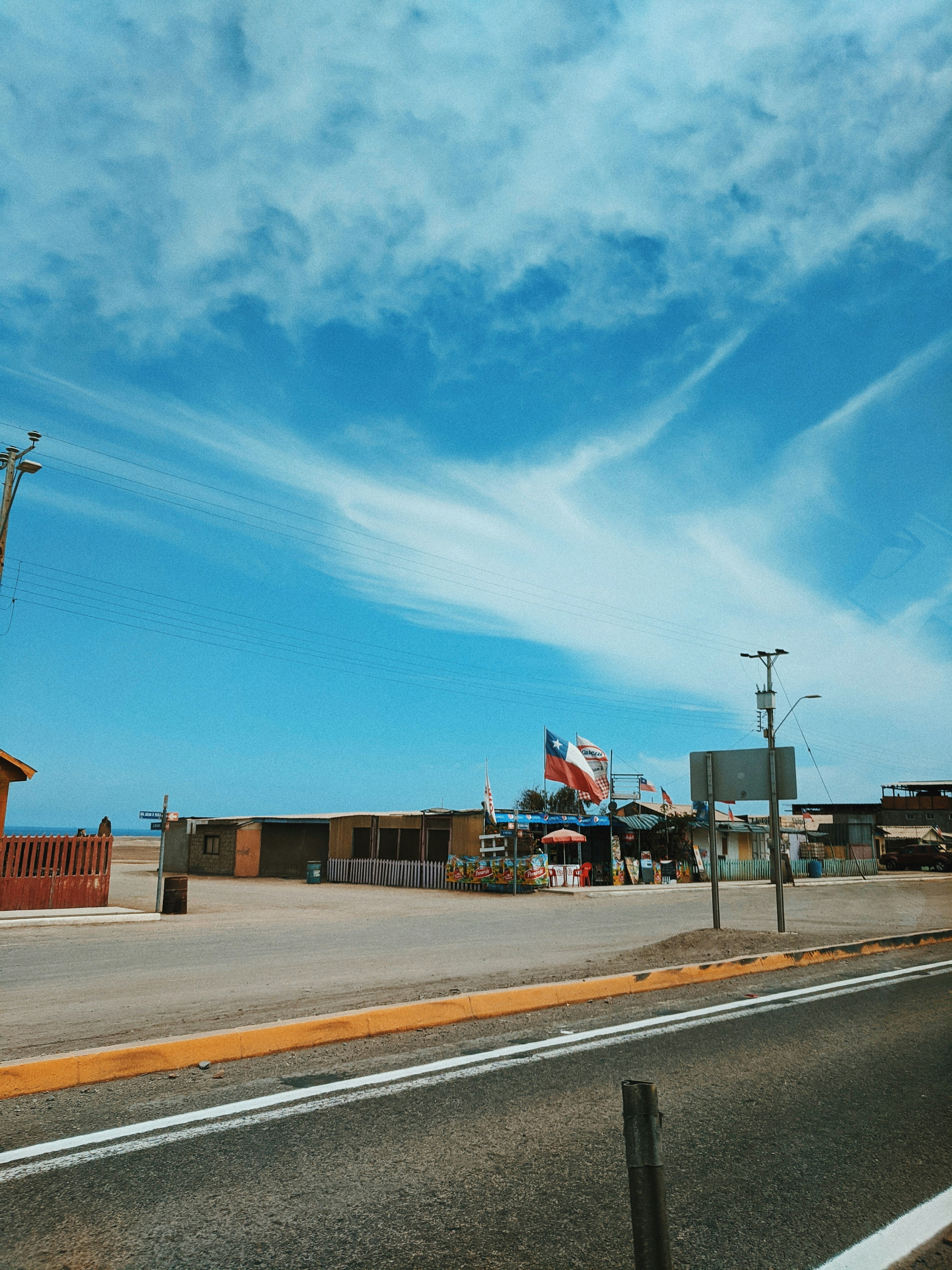 a street with a stop sign and a building in the background