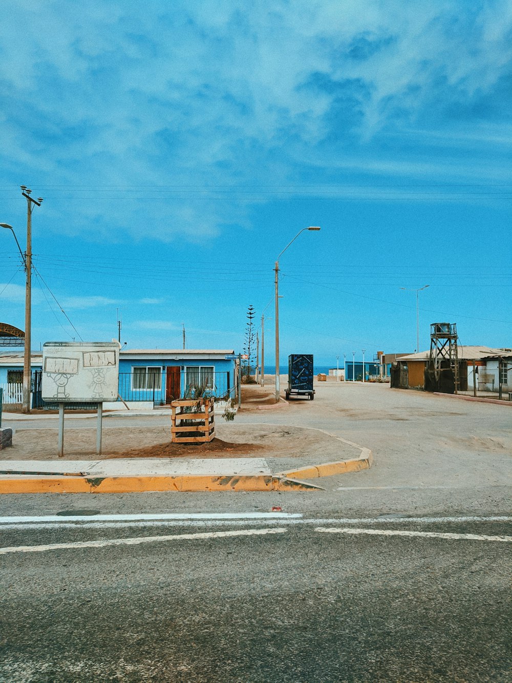 an empty street with a blue sky in the background