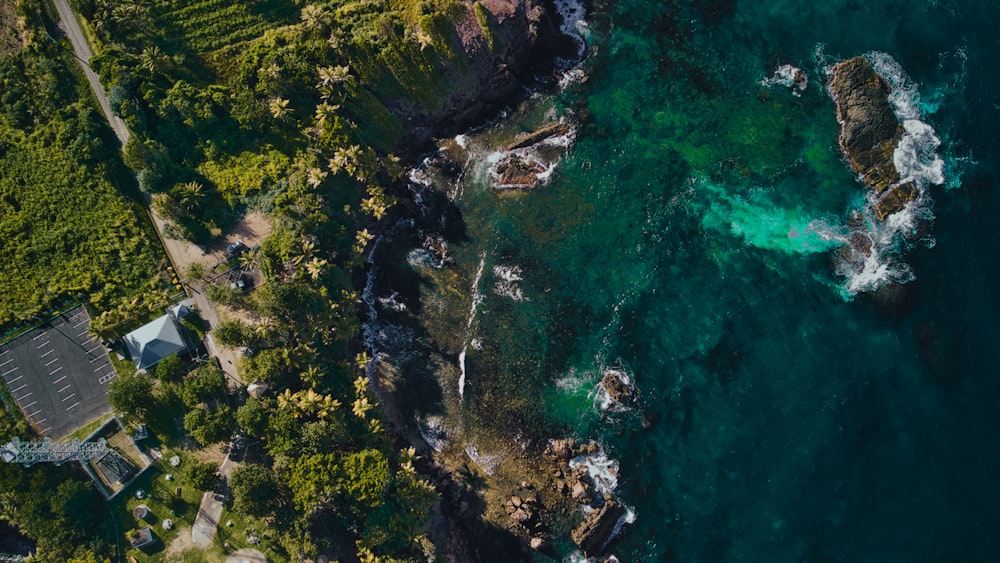 an aerial view of the ocean and a house