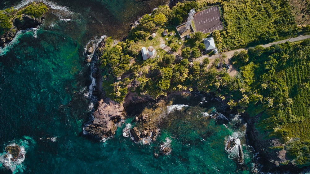 an aerial view of a house on a cliff next to the ocean