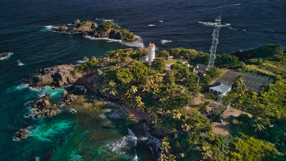 an aerial view of an island with a lighthouse
