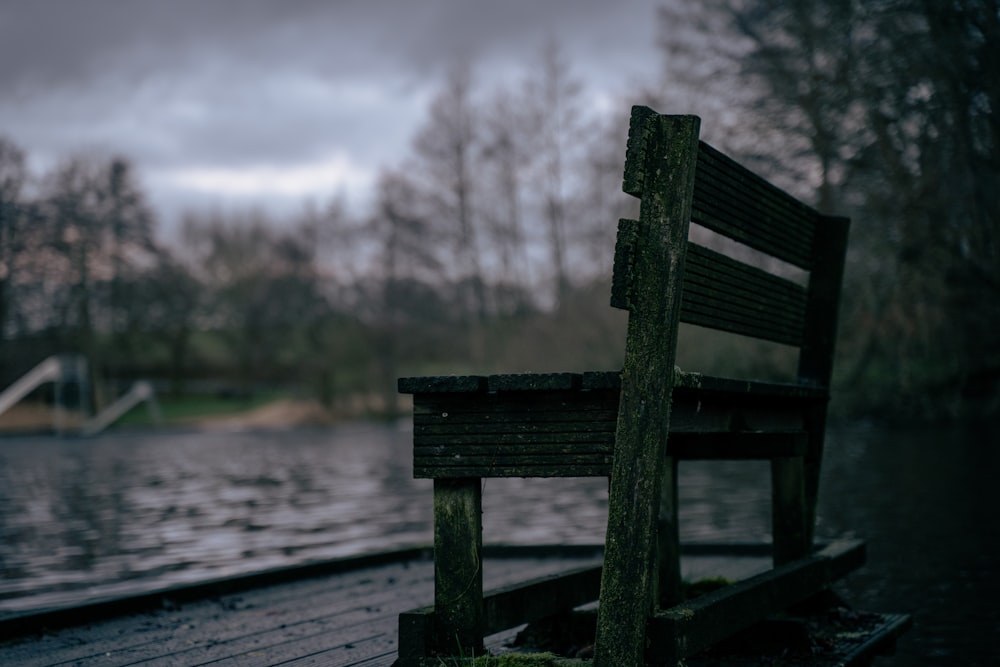 a wooden bench sitting next to a body of water