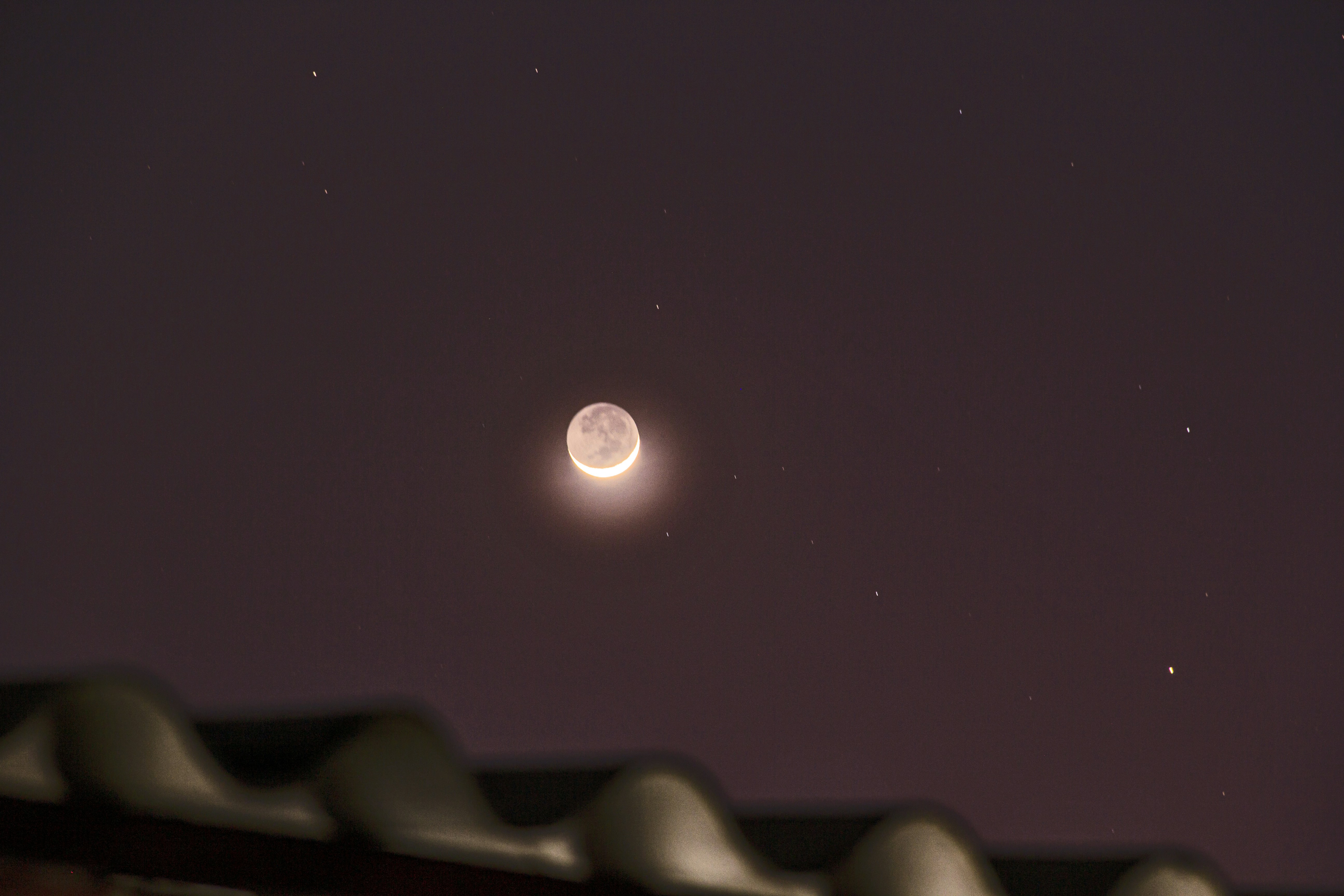 A view of the moon from a roof at night photo – Free Moon Image on Unsplash